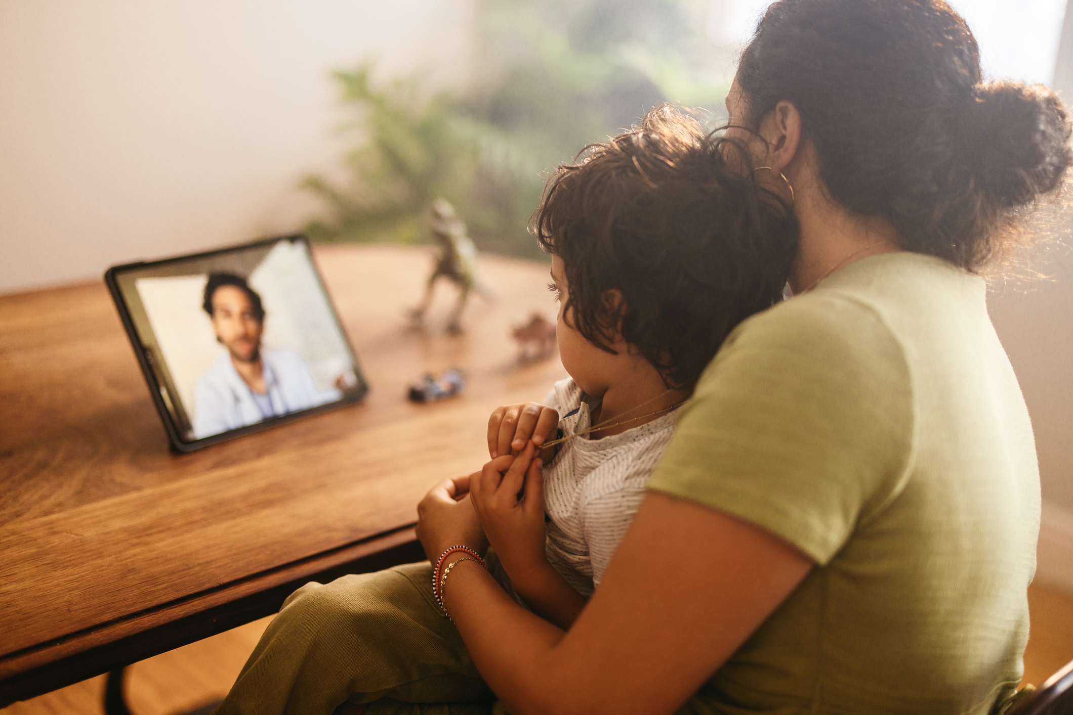 mother and child videoconferencing with pediatrician